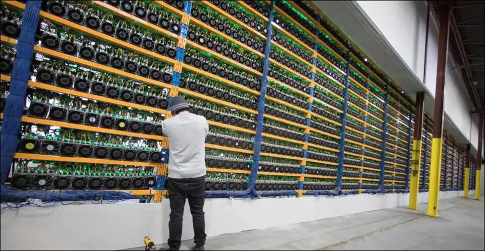 A modern mining farm with rows of mining rigs